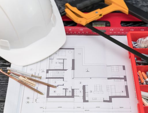 Construction design documentation and tools on the table. Home improvement concept.